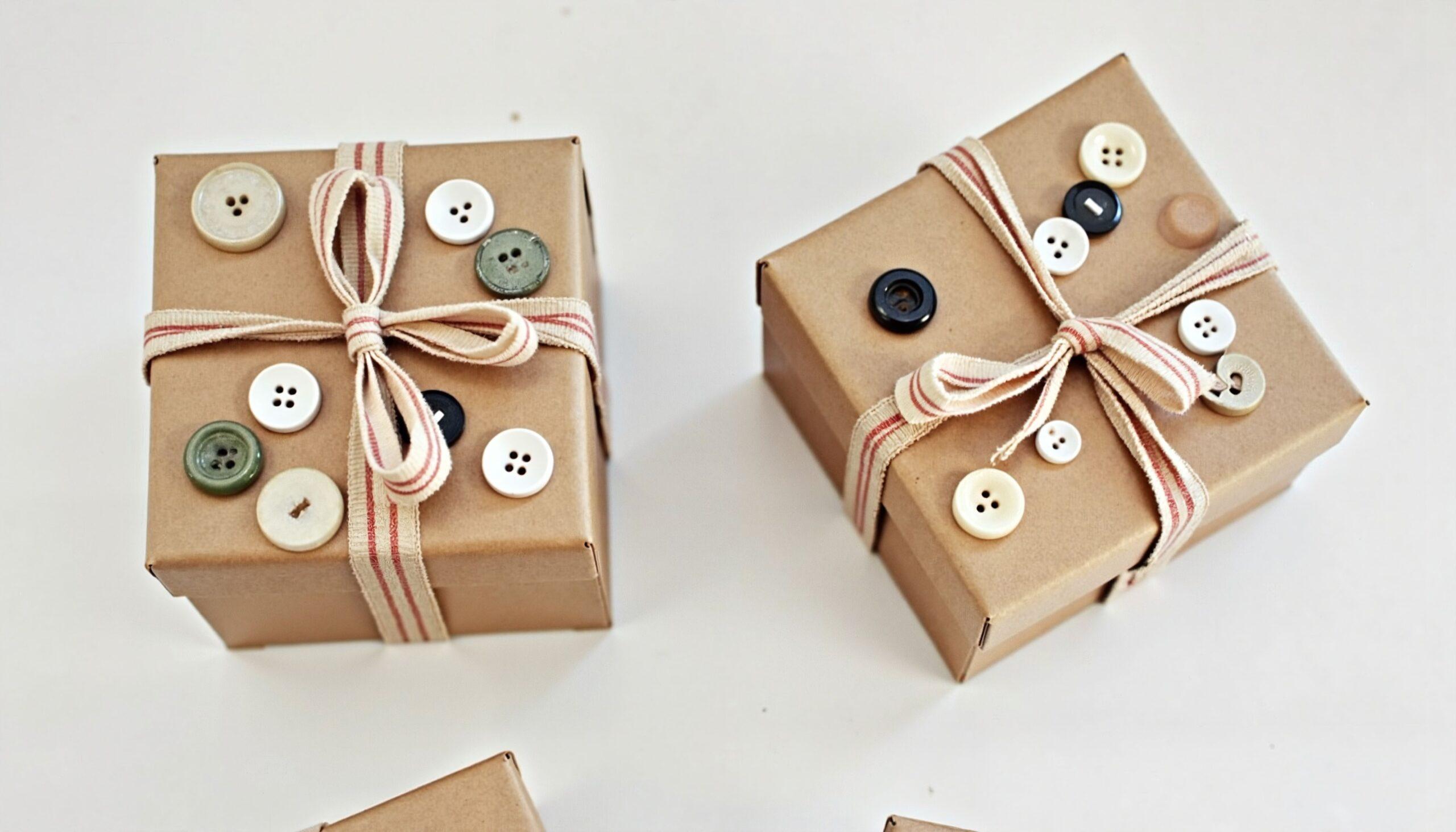 Nachhaltig verpackte Geschenke mit Stoffband und Knopf-Deko